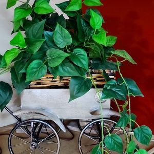 Plastic plant decoration in wicker basket.